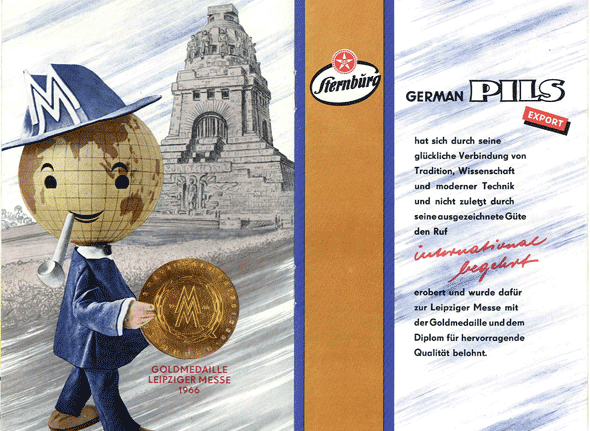 Eine Zeichnung zeigt eine maskottchenähnliche Figur vor einer historischen Architektur, die eine Medaille hält.